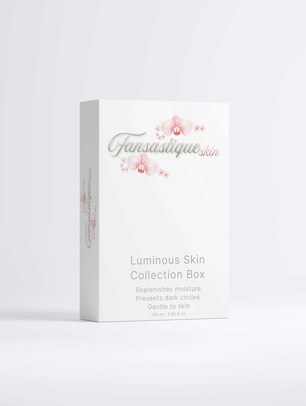 Luxe skincare set voor hydratatie en donkere kringen in witte doos met roze bloemen.